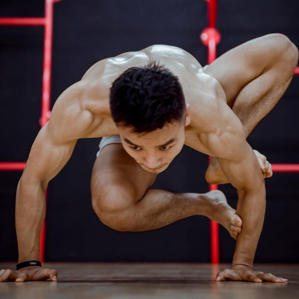 man performing hard yoga position